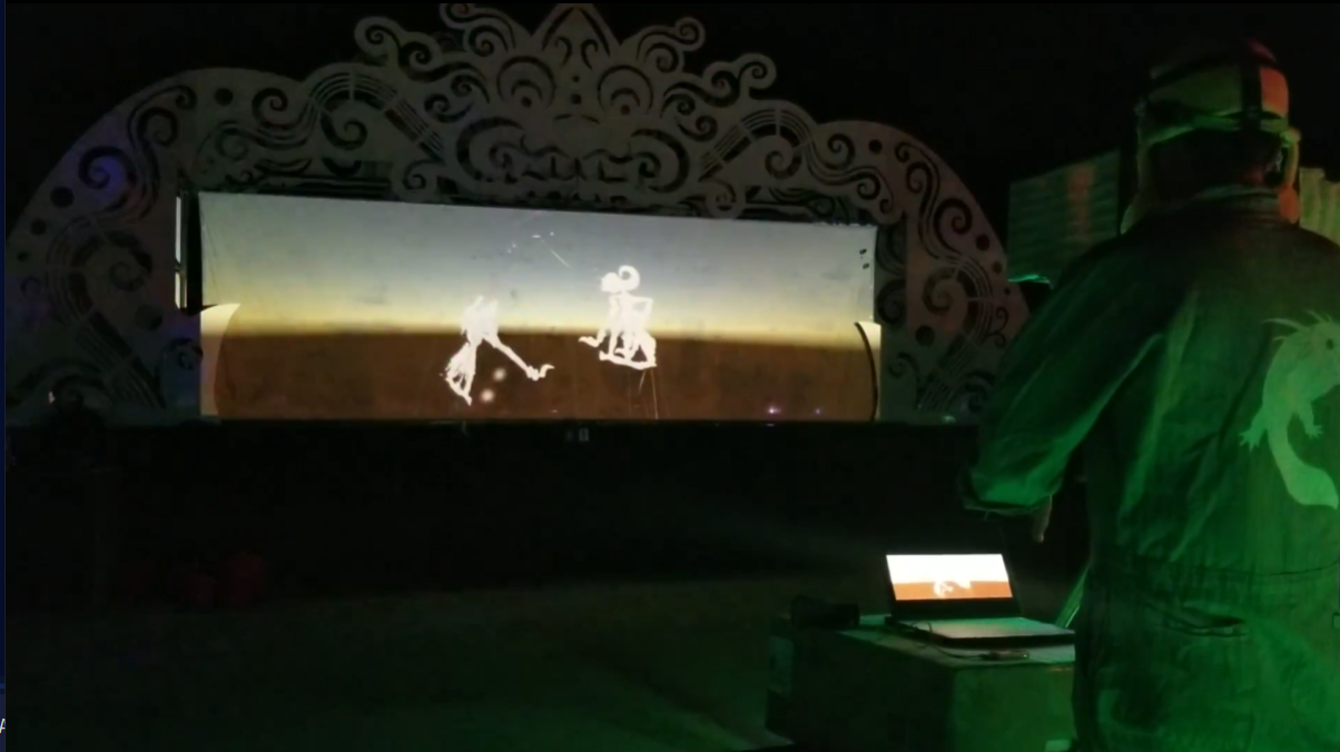 Digital Dalang virtual shadow puppets projected on an ornate Wayang Kulit screen at night